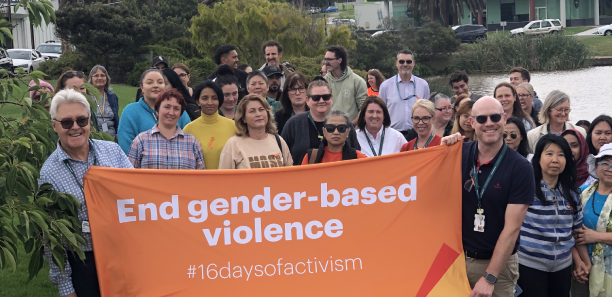 TAFE Gippsland staff holding up an End gender-based violence banner