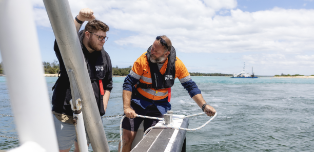 TAFE Gippsland trainer instructing a student on deck of a boat