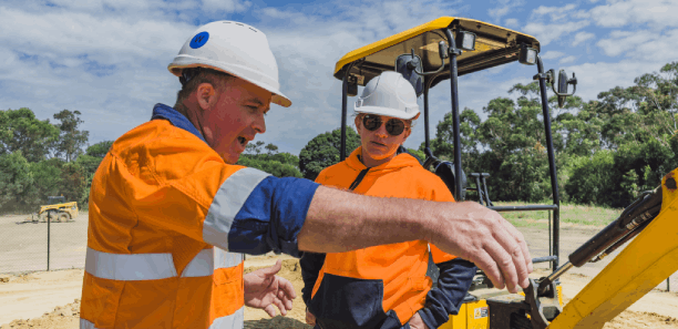 Civil construction teacher Kevin Hayes giving student Hollie some tips at TAFE 