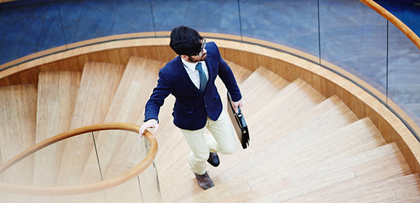 Man in suit going up the stairs