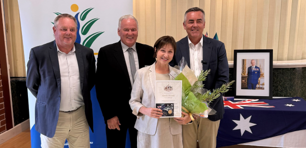 Zhanna Voronkova receives her Australian Citizenship certificate from local, state and federal government officials